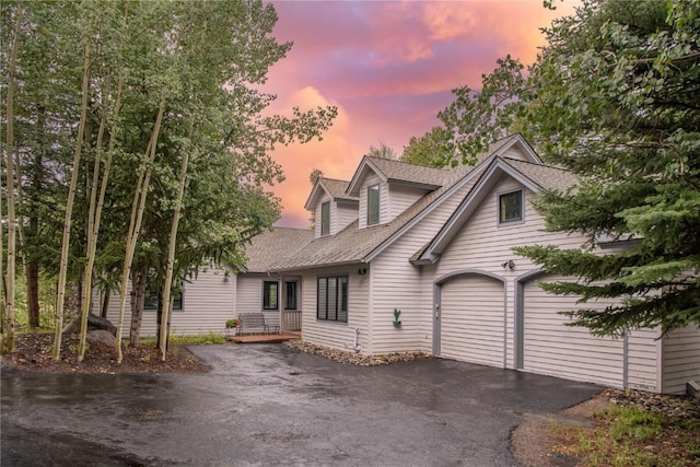 cape cod-style house featuring a garage