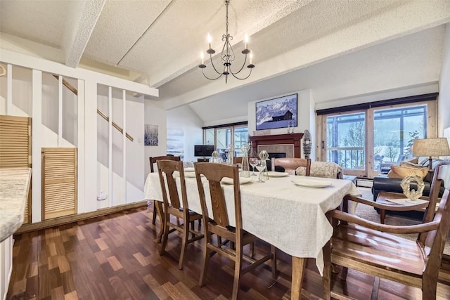 dining area with vaulted ceiling with beams, a wealth of natural light, a textured ceiling, and an inviting chandelier