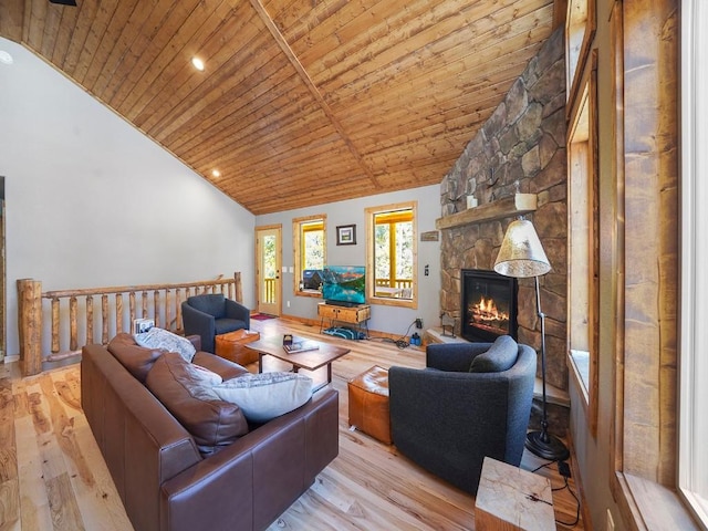 living room featuring light hardwood / wood-style flooring, wooden ceiling, vaulted ceiling, and a fireplace