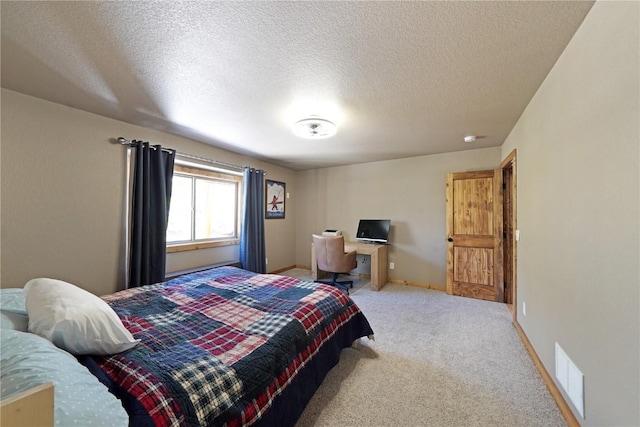 carpeted bedroom with a textured ceiling