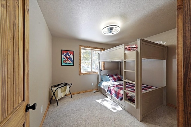 carpeted bedroom with a textured ceiling