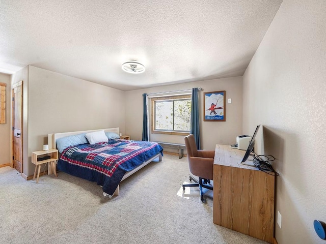 bedroom with a textured ceiling and carpet floors