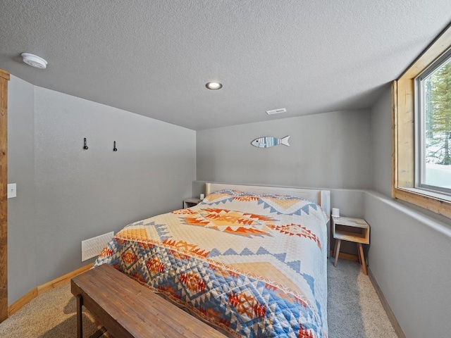 carpeted bedroom featuring a textured ceiling