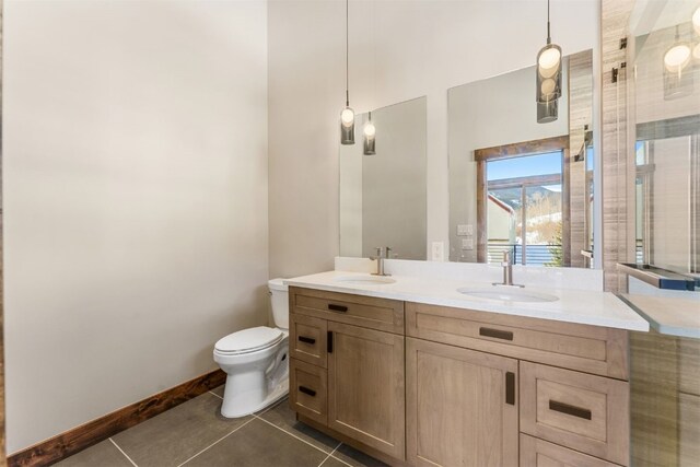 bathroom featuring tile patterned floors, vanity, and toilet