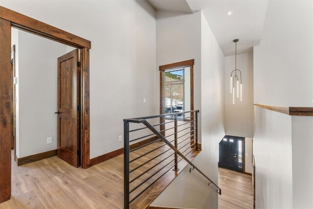 staircase featuring hardwood / wood-style flooring and a towering ceiling