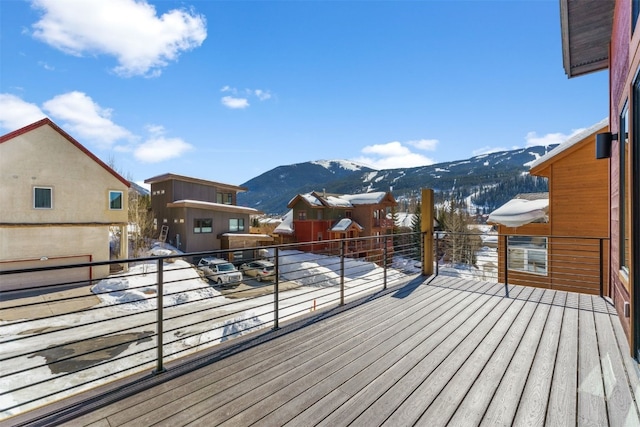 snow covered deck featuring a mountain view