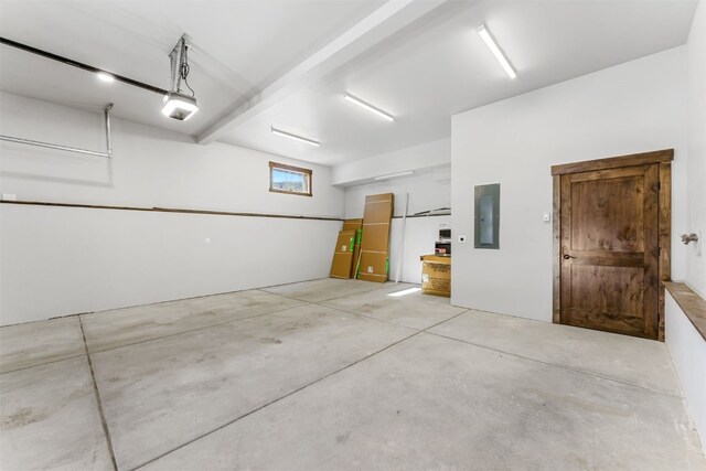 garage with electric panel and a garage door opener