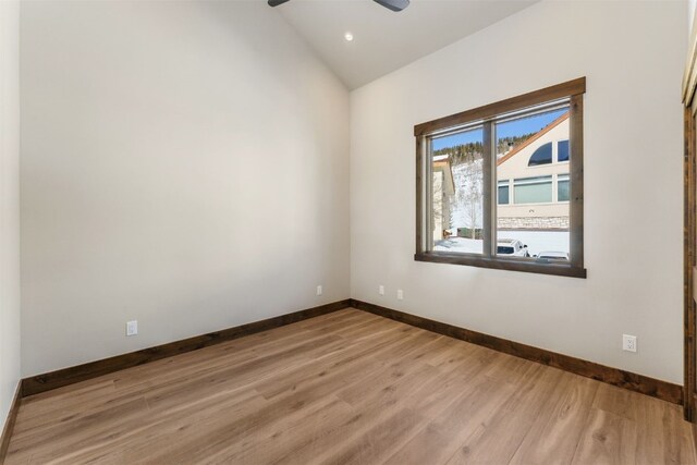 unfurnished room featuring hardwood / wood-style flooring, ceiling fan, and lofted ceiling