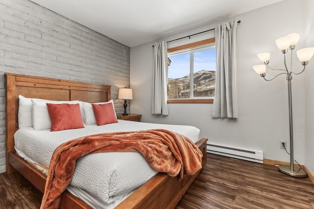 bedroom with baseboard heating, a chandelier, and dark wood-type flooring