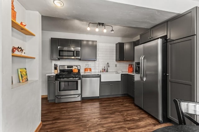 kitchen featuring gray cabinetry, sink, dark hardwood / wood-style flooring, and stainless steel appliances