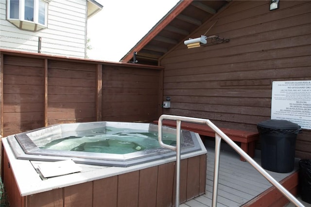 deck with an outdoor hot tub