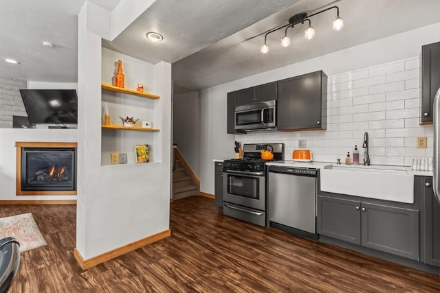 kitchen featuring gray cabinets, appliances with stainless steel finishes, sink, and dark wood-type flooring