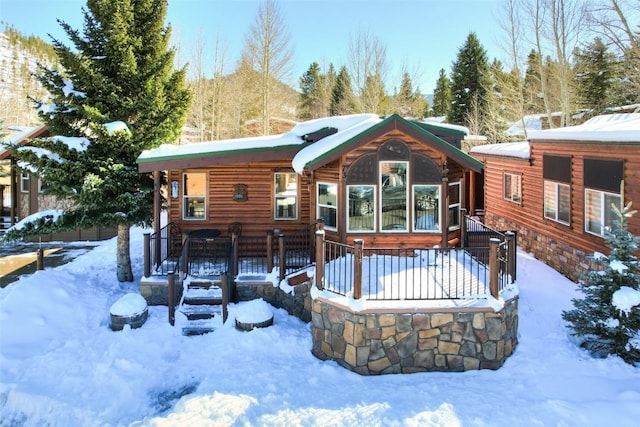 view of snow covered back of property