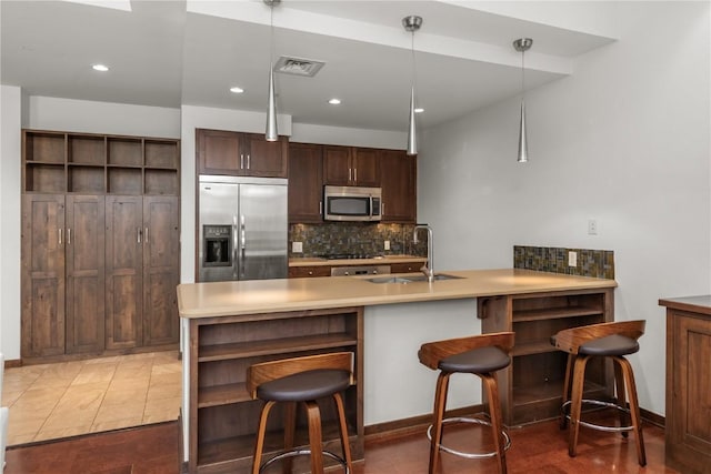 kitchen with a sink, stainless steel appliances, tasteful backsplash, and open shelves