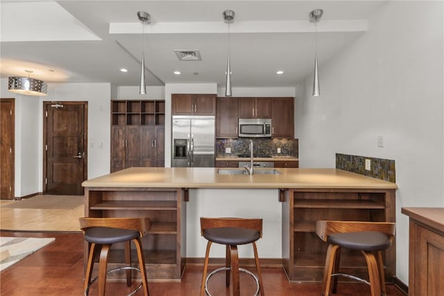 kitchen with decorative backsplash, a kitchen breakfast bar, stainless steel appliances, open shelves, and a sink