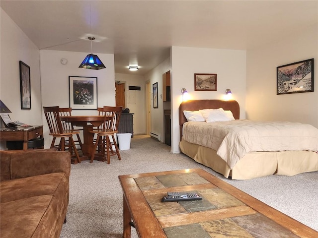 carpeted bedroom featuring a baseboard heating unit