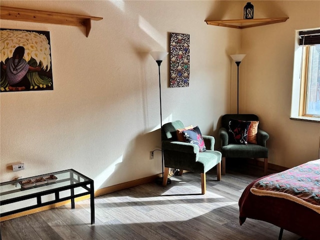 bedroom with beam ceiling and wood-type flooring