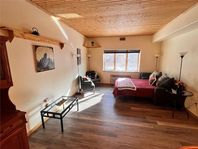 bedroom with wooden ceiling and dark hardwood / wood-style floors