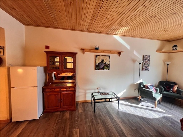 sitting room with dark hardwood / wood-style flooring, wooden ceiling, and crown molding