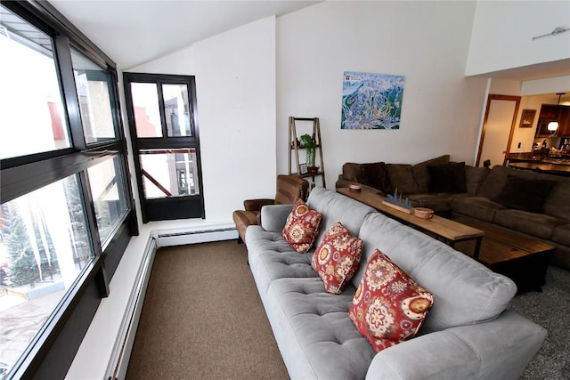 carpeted living room with baseboard heating and lofted ceiling