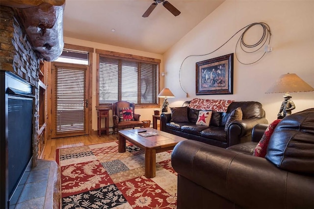 living room featuring ceiling fan, wood-type flooring, and lofted ceiling