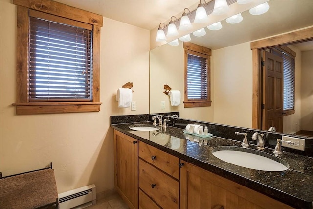 bathroom with tile patterned floors, vanity, and baseboard heating