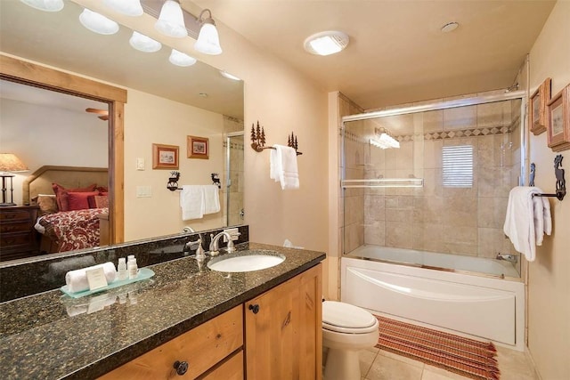 full bathroom featuring tile patterned floors, vanity, enclosed tub / shower combo, and toilet