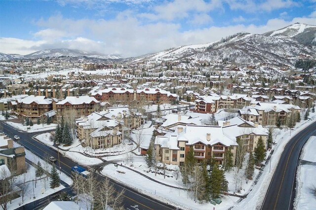 snowy aerial view with a mountain view