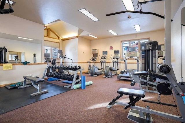 workout area featuring a wall mounted air conditioner, carpet, and lofted ceiling