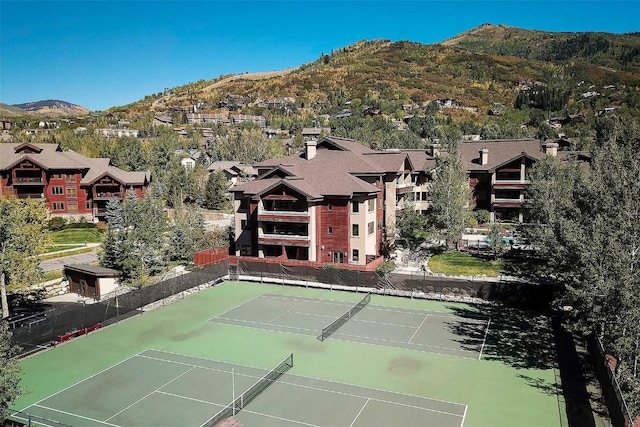 view of tennis court featuring a mountain view