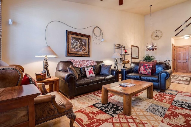 living room with ceiling fan and light hardwood / wood-style flooring