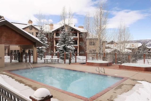 snow covered pool with a patio area