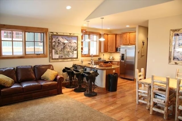 living room featuring sink and light wood-type flooring