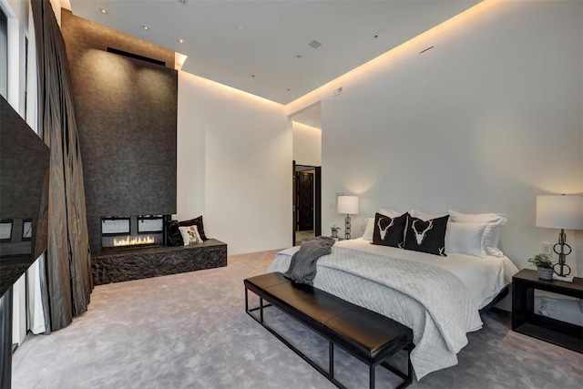 carpeted bedroom with a fireplace