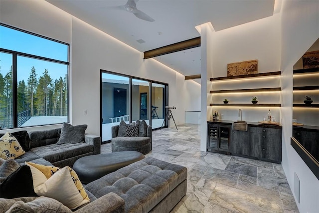 living room with lofted ceiling with beams, wine cooler, and ceiling fan