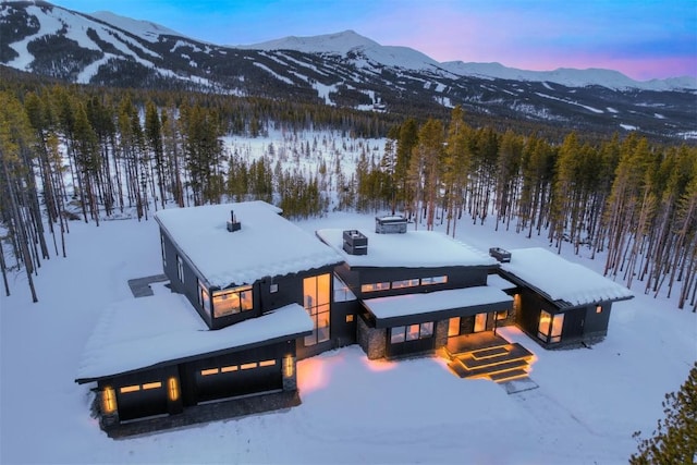 snowy aerial view featuring a mountain view