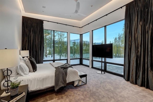 bedroom with access to exterior, light colored carpet, and ceiling fan