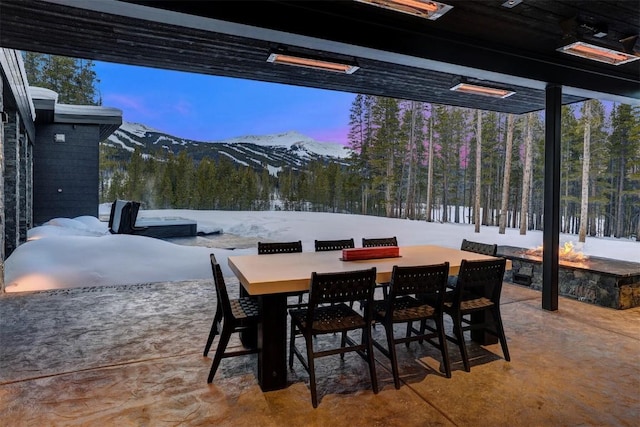 snow covered patio featuring a mountain view