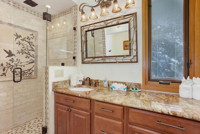 bathroom with vanity, a shower stall, and visible vents