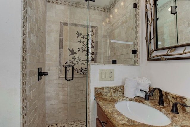 bathroom featuring a stall shower and vanity