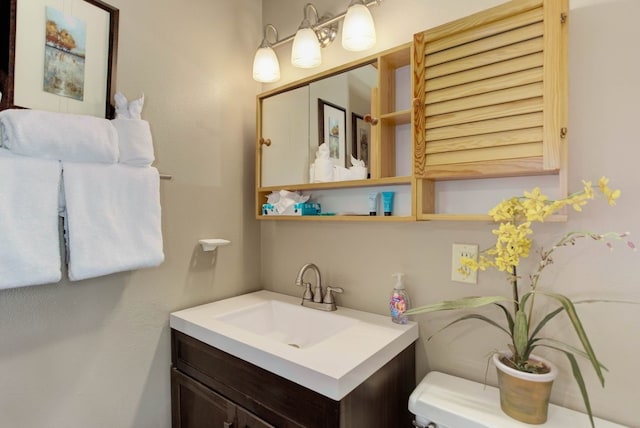 bathroom with toilet and vanity