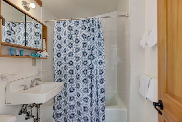 bathroom featuring shower / bath combo and a sink