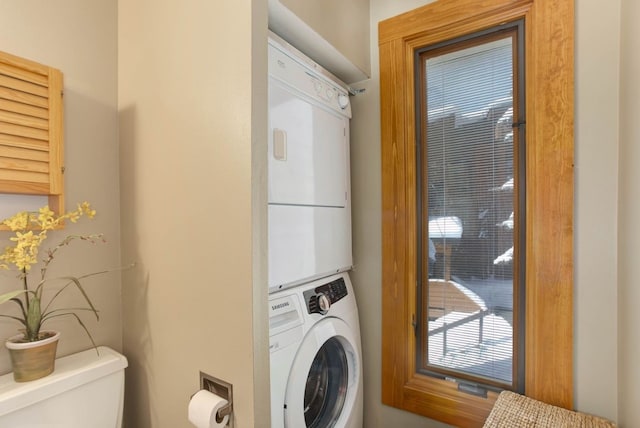 washroom featuring stacked washing maching and dryer and laundry area