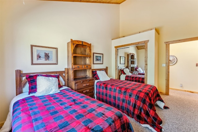 bedroom featuring a closet, carpet floors, and high vaulted ceiling