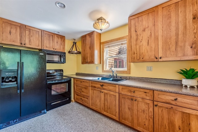 kitchen with sink, black appliances, and decorative light fixtures