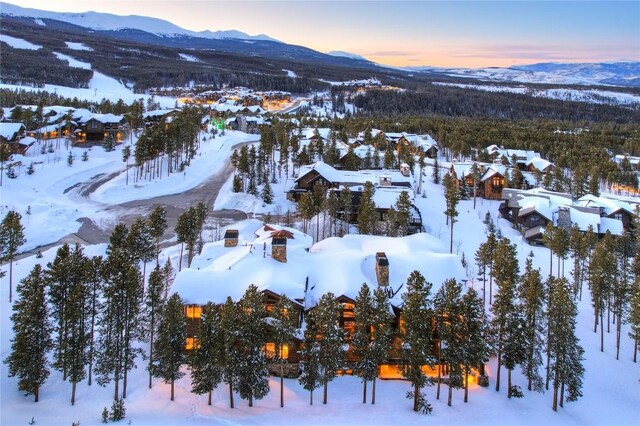 snowy aerial view featuring a mountain view