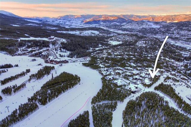 snowy aerial view with a mountain view