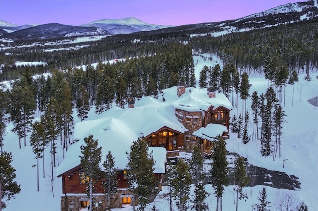 snowy aerial view with a mountain view