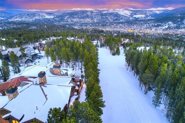 snowy aerial view featuring a mountain view