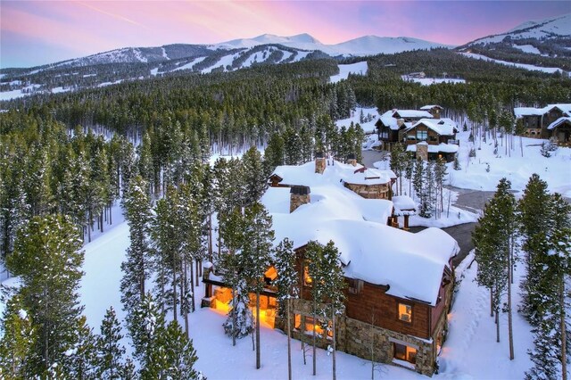 snowy aerial view with a mountain view